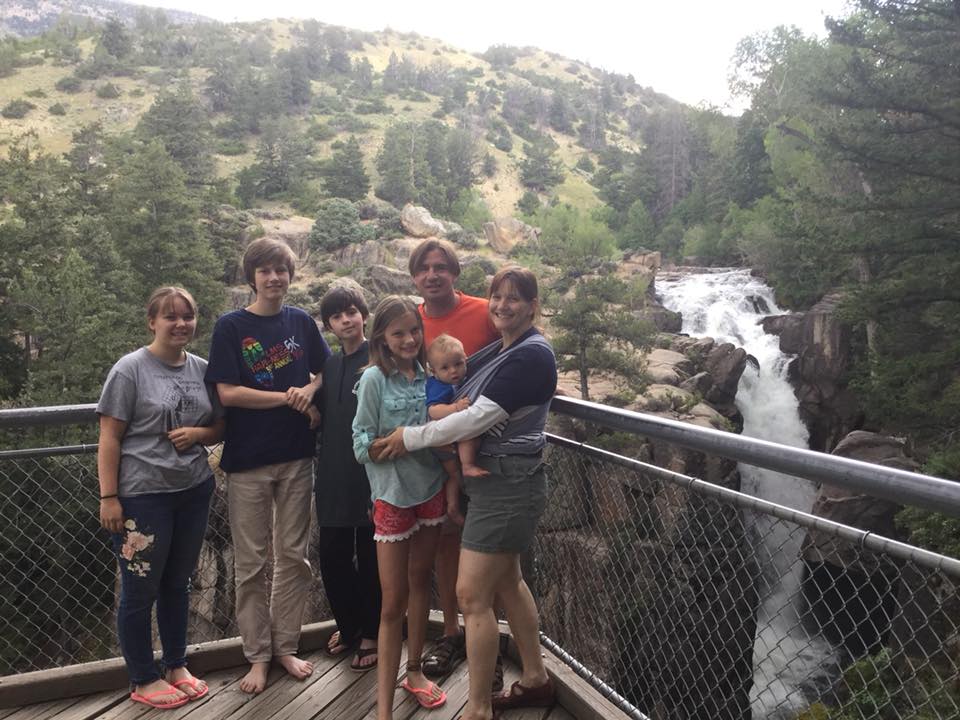 Dan Fetsco poses in front of a Shell Falls in northern Wyoming with his family